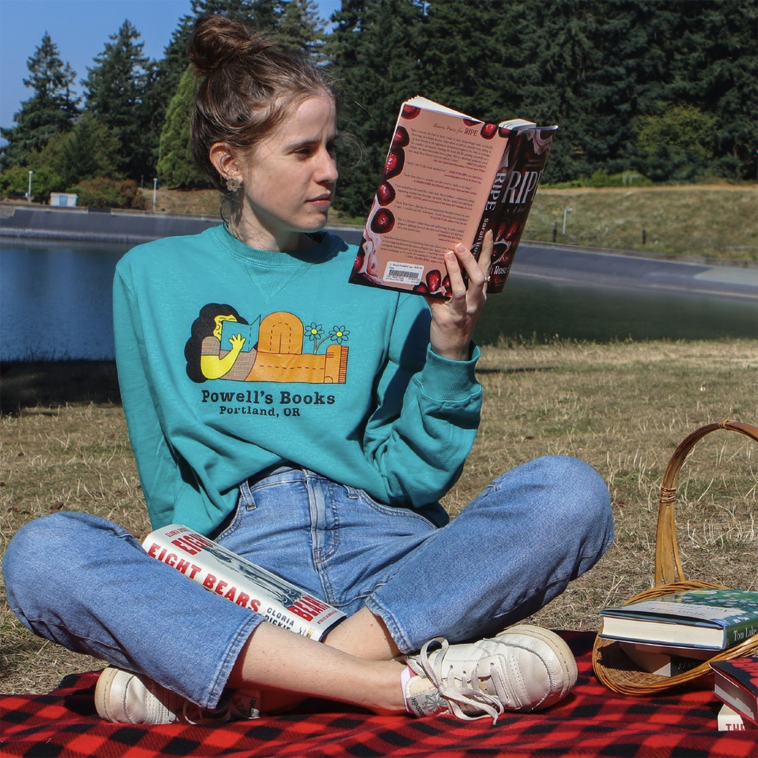 Powell's Book Girl Reading On a Blanket by the water